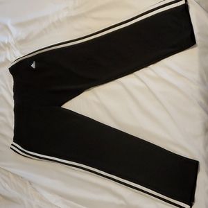 Adidas track pants with zipper at bottom of leg.